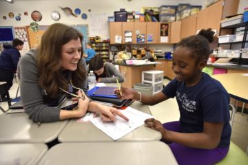 Park Forest Elementary teacher Michele White works with one of her students during a math lesson. From a new workshop series for teachers, White has learned ways of helping her students explore and enjoy math.