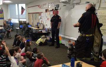 Deputy Chief Andy Moletzsky (left) and firefighter Aaron Voegtli (right) talked about their job and shared fire safety tips with the students.